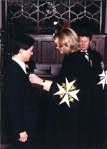 Derwin Mak receiving the decoration of a Serving Brother of the Order of St. John from Hilary Weston, Lt. Governor of Ontario, June 1999.